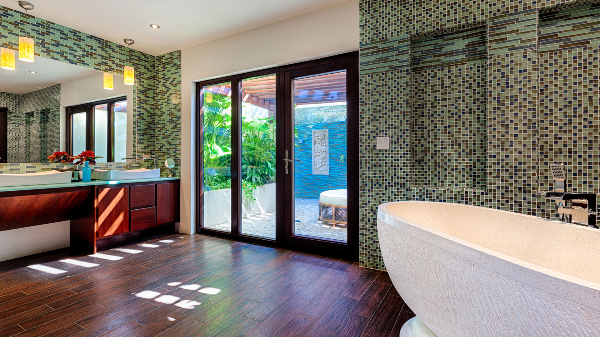 Neveah Villa boasts luxury bathrooms complete with a tub, shower, and outdoor shower